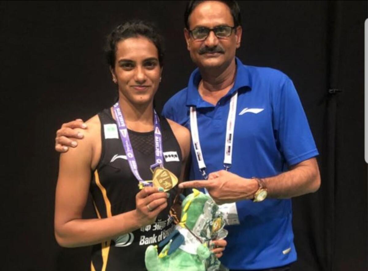 Former Indian volleyball player PV Ramana with his daughter PV Sindhu after she won the gold medal at the 2019 World Badminton Championships. – Supplied photo