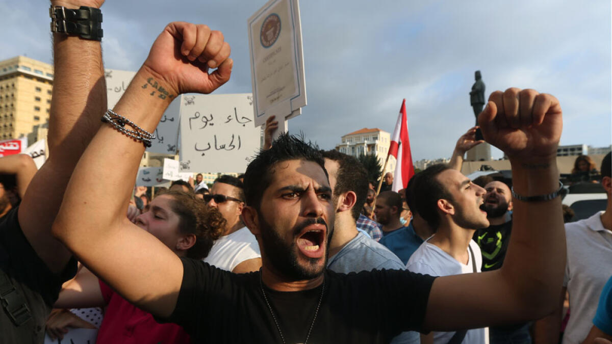 Lebanese activists chant slogans during a protest against the ongoing trash crisis, in downtown Beirut, Lebanon.