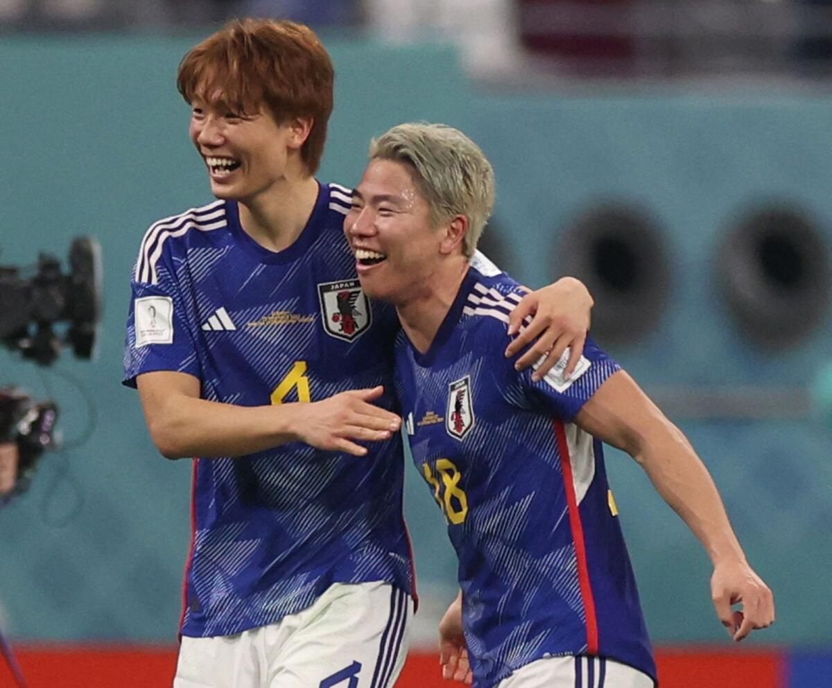 Japan's Kou Itakura and Takuma Asano celebrates after the match. Photo: Reuters