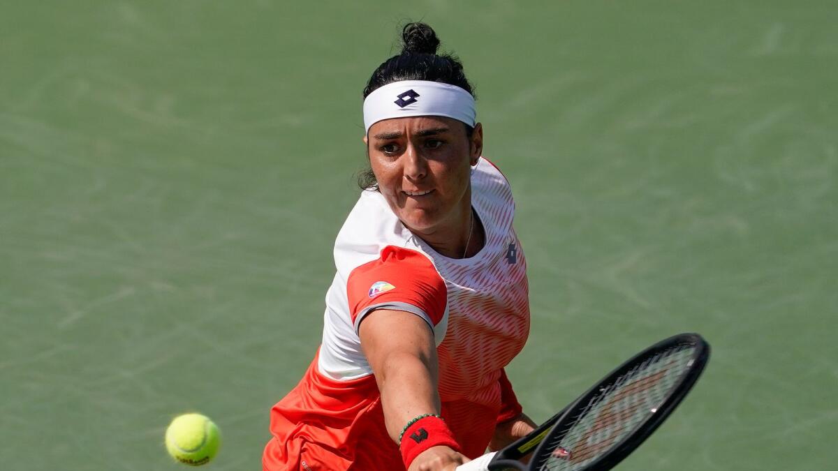 Ons Jabeur of Tunisia hits a return against Elizabeth Mandlik of the United States during their second round match. (AP)
