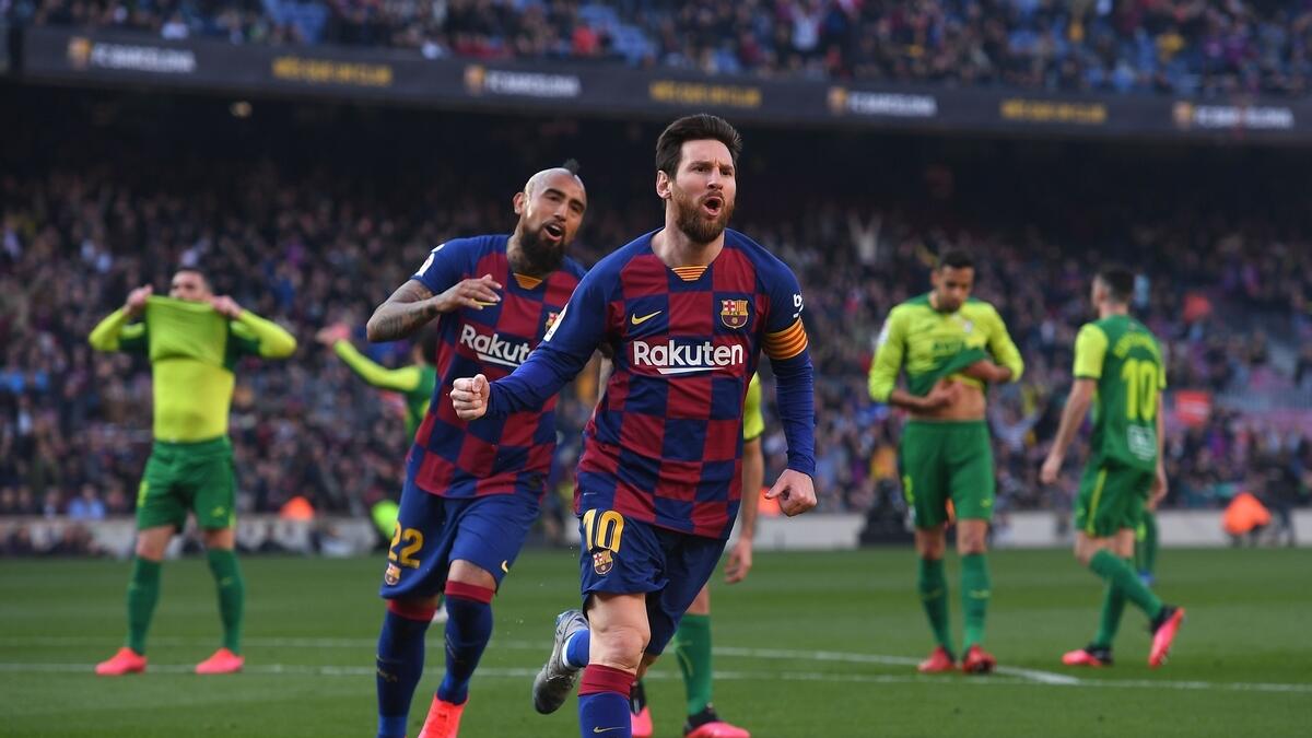 BACK TO HIS BEST: Lionel Messi (right) celebrates after scoring a goal against SD Eibar during the Spanish League match.