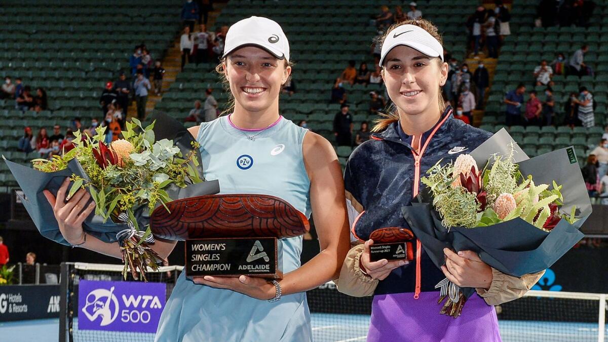 Iga Swiatek of Poland (left) poses with Switzerland's Belinda Bencic following her victory in their women's singles final match at the Adelaide International tennis tournament. — AFP