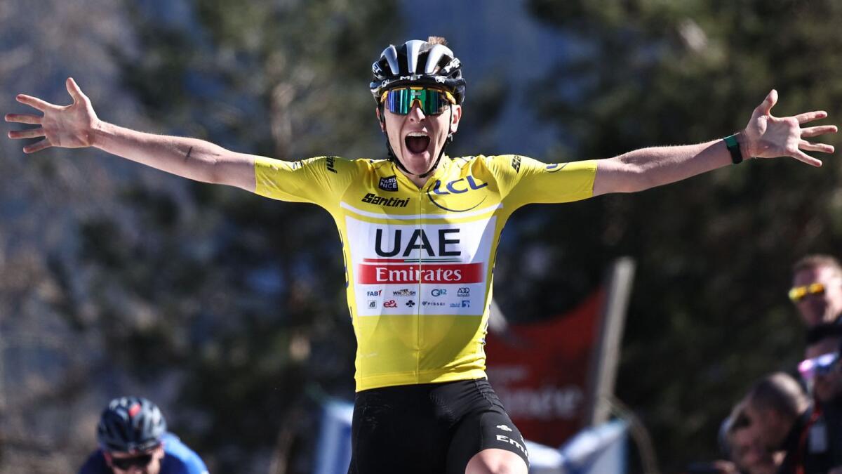 UAE Team Emirates' Slovenian rider Tadej Pogacar celebrates as he crosses the finish line to win the seventh stage of the 81st Paris-Nice cycling race on Saturday. — AFP