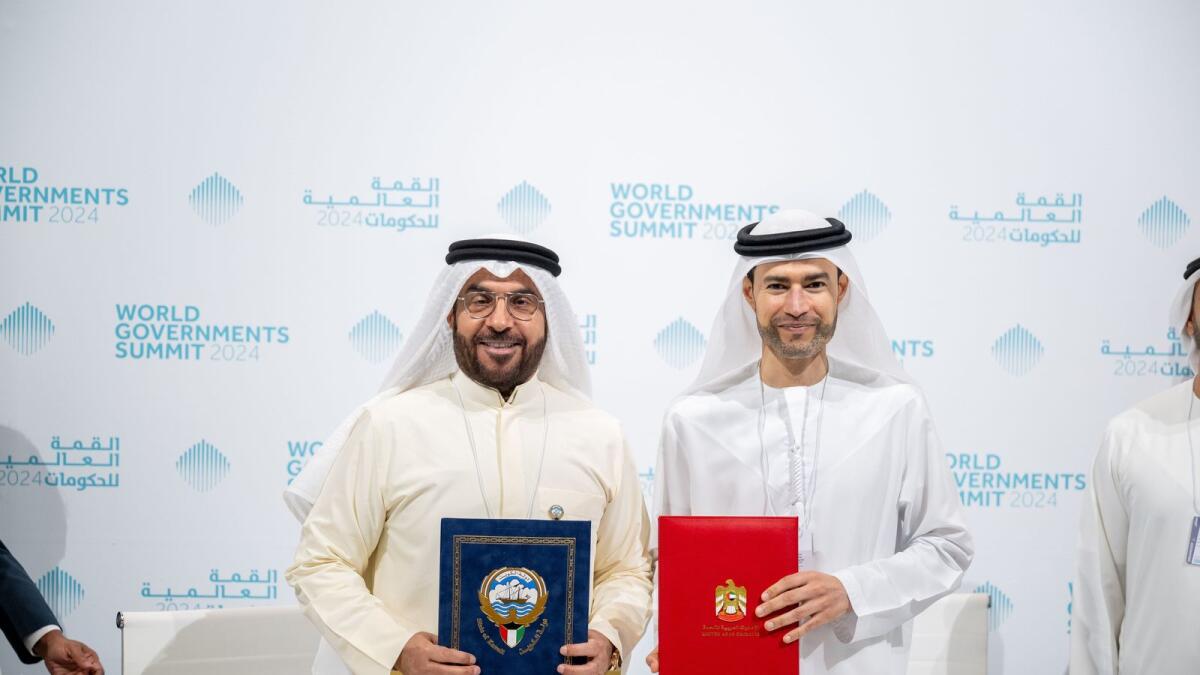 UAE and Kuwait ministers after signing the agreement. — Wam