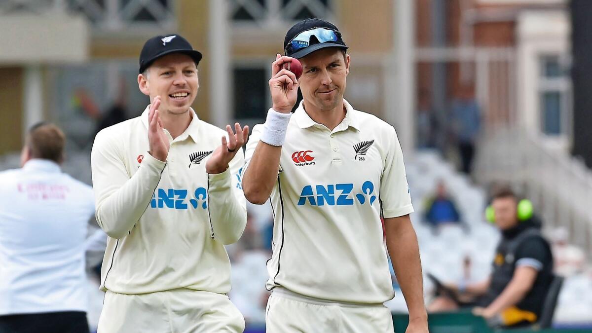 Well bowled: New Zealand pacer Trent Boult holds up the ball after takingfive wickets against England. — AP