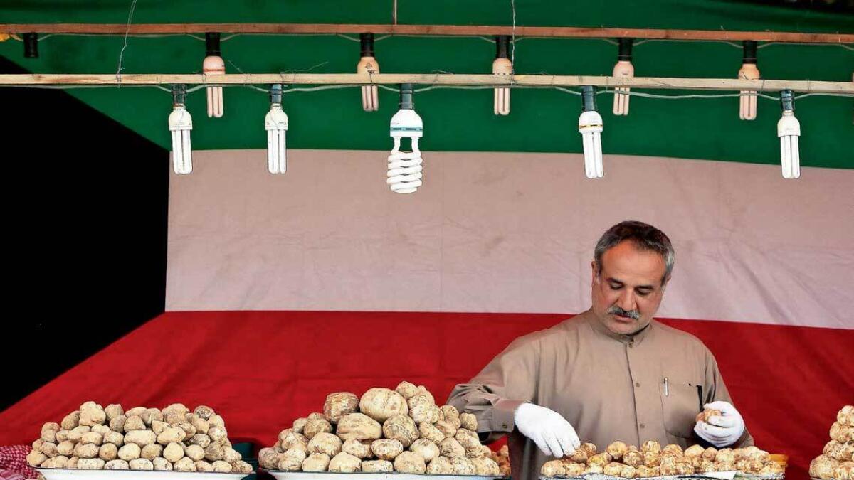 A Kuwaiti vendor arranges truffles for sale at a market in Al Rai, an industrial zone northwest of Kuwait City. — AFP