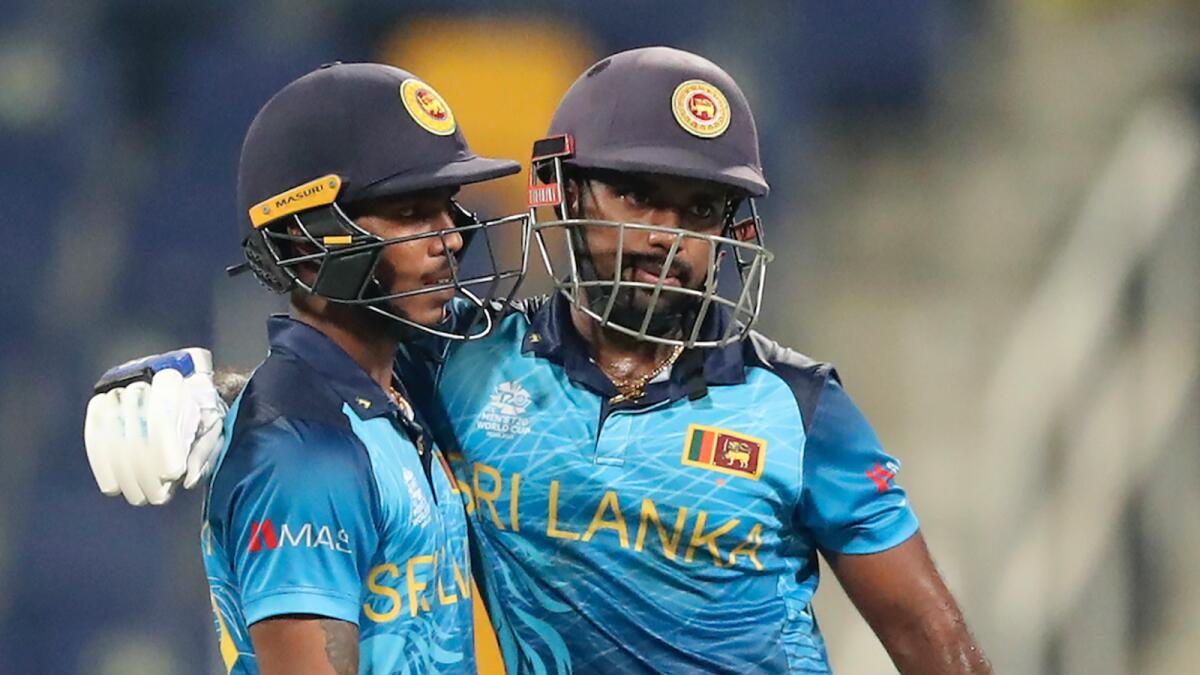 Sri Lanka’s Charith Asalanka (right) and Pathum Nissanka celebrate after putting on a 91-run partnership against the West Indies in Abu Dhabi on Thursday. — AP