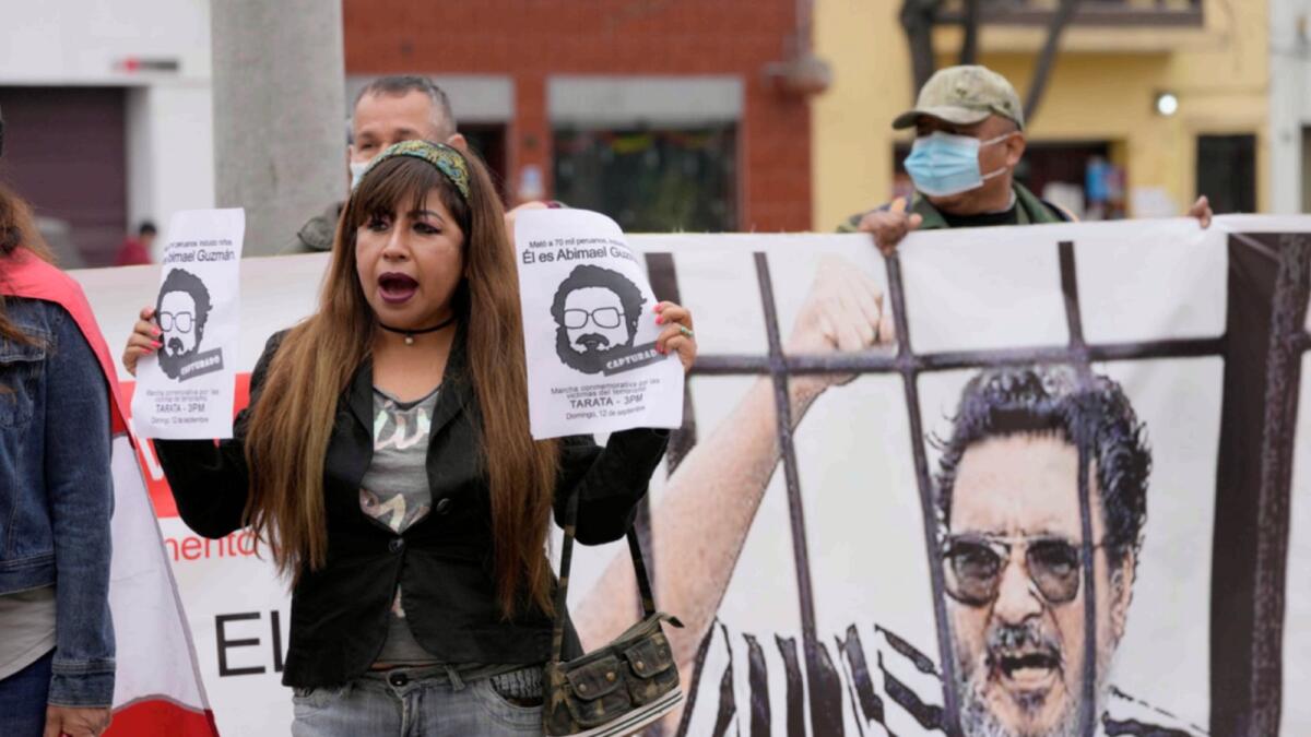 People gather outside the anti-terrorism directorate in Lima to celebrate the death of Abimael Guzman. — AP