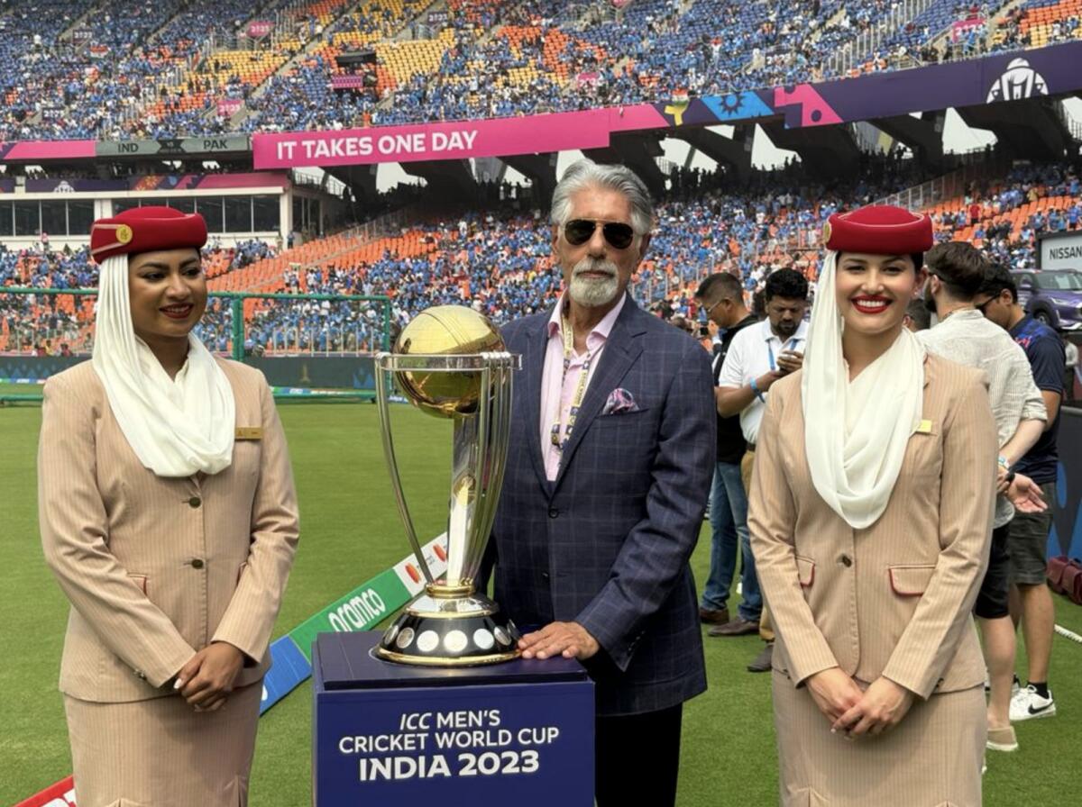 Shyam Bhatia poses with the ICC World Cup trophy and members of Emirates Airlines’ cabin crew at the Narendra Modi Stadium in Ahmedabad. — Supplied photo