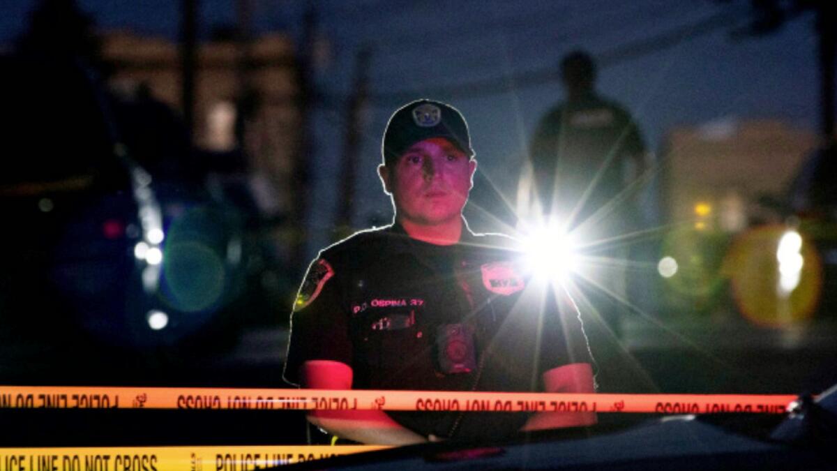 A New Jersey police officer stands guard near the building where alleged attacker of Salman Rushdie, Hadi Matar, lives in Fairview. — Reuters