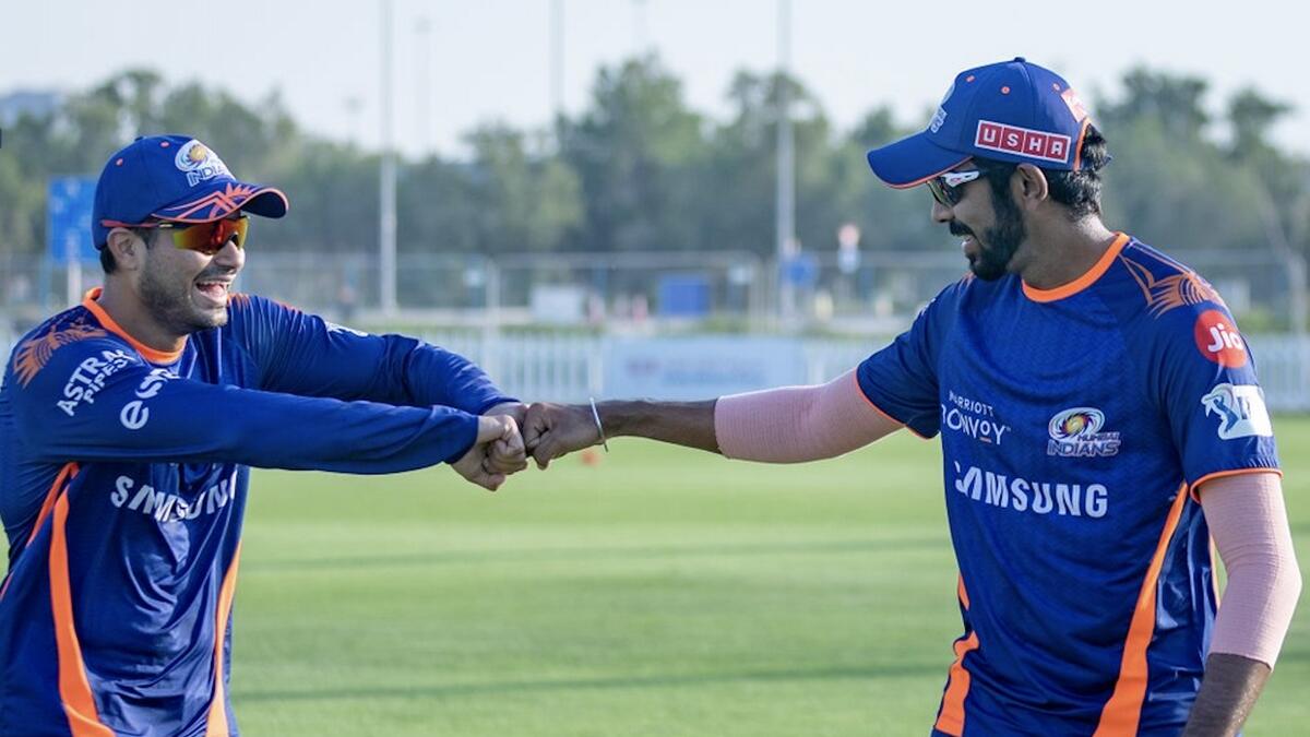 Mumbai Indians' Aditya Tare (left) and teammate Jasprit Bumrah fist bump during a training session. - Mumbai Indians Twitter