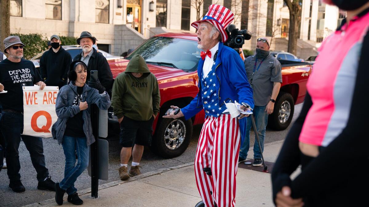 A man riding a Segway dressed as Uncle Sam taunts Biden supporters during a 'Stop the Steal' rally outside the Georgia State Capitol on November 18, 2020.