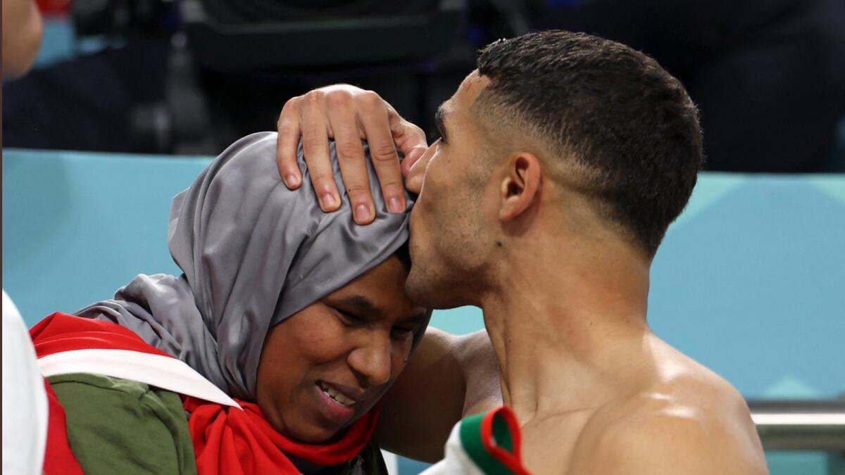 Achraf Hakimi kisses his mother after his team's win against Belgium.