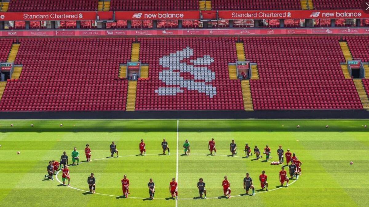 Liverpool players showed their solidarity with the Black Lives Matter movement by taking a knee around the centre circle at Anfield on Monday (Twitter)