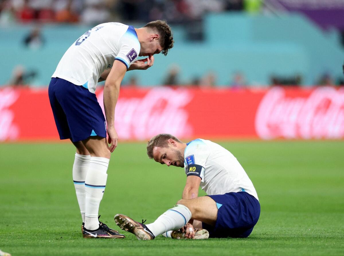 England's Harry Kane (right) reacts after sustaining an injury as Harry Maguire looks on. (Photo: Reuters)