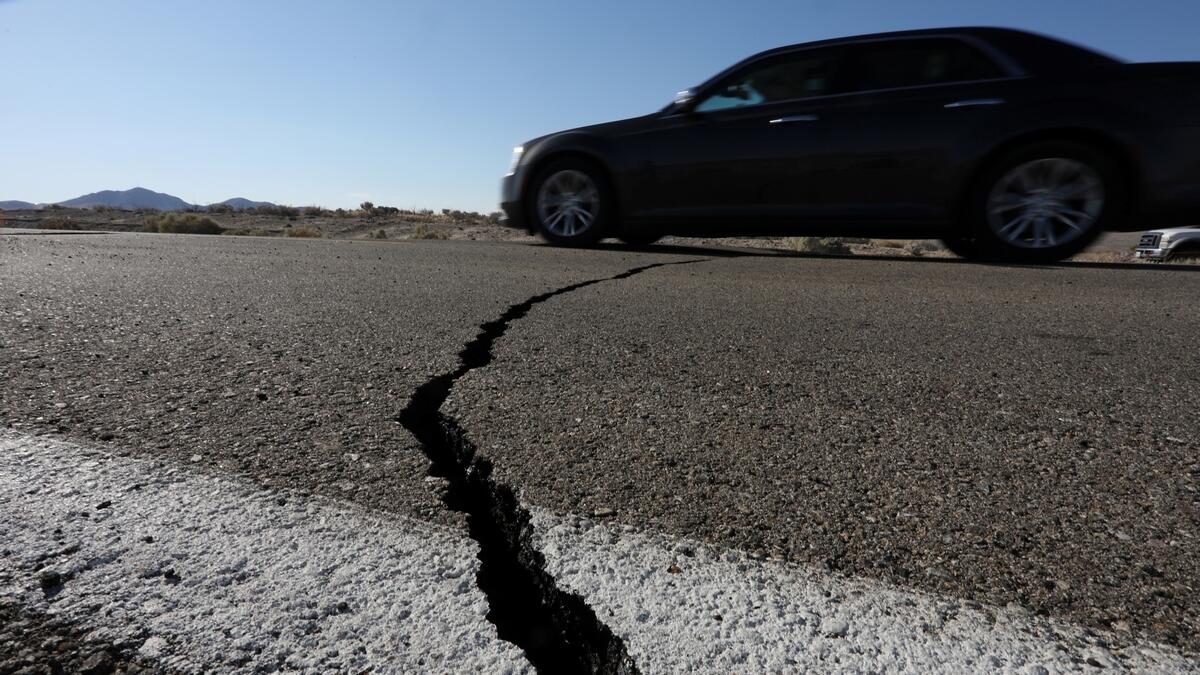 A car passes over a fissure that opened on a highway during a powerful earthquake that struck Southern California, near the city of Ridgecrest, California, US.- Reuters