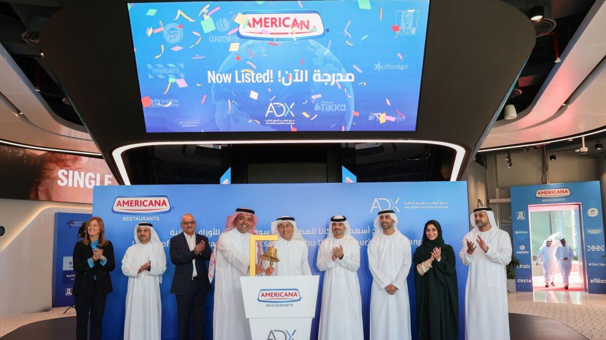 Mohamed Ali Rashed Alabbar, chairman of Americana Restaurants, rang the market opening bell for the official dual listing ceremony on Monday at ADX, accompanied by Hisham Khalid Malak, chairman of ADX.— Supplied photo