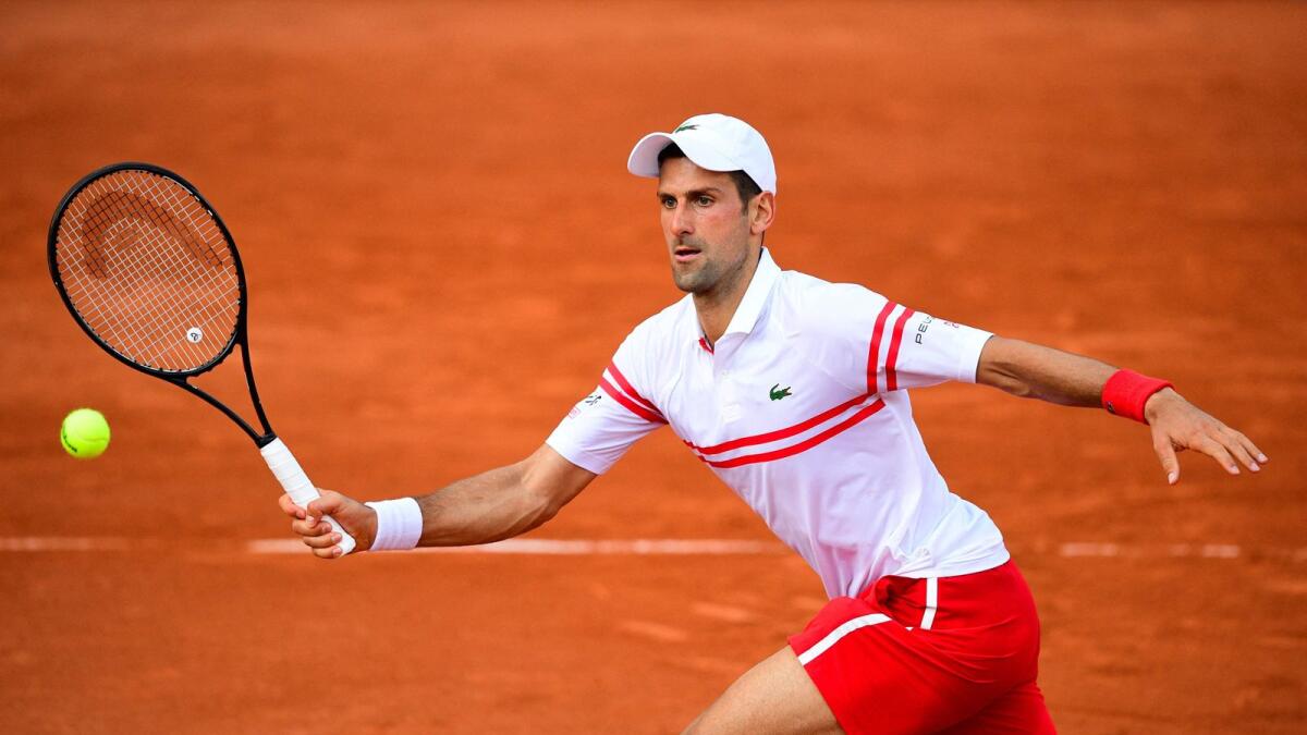 Serbia's Novak Djokovic returns the ball to Uruguay's Pablo Cuevas during their men's singles second round match. — AFP
