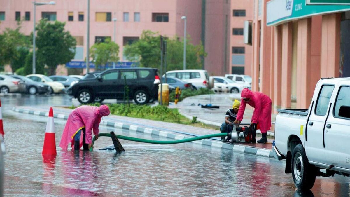 Municipality workers use pumping equipment to drain out accumulated water in Dubai’s Discovery Gardens. Some roads were flooded with water, prompting authorities to close them temporarily.