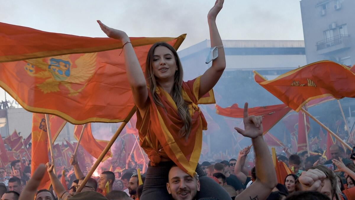 Self-described patriots wave flags during a post-election rally in Podgorica. Supporters of President Milo Djukanovic and his Democratic Party of Socialists (DPS) have staged a rally in support of Montenegro's sovereignty, as local media report. Photo: AFP