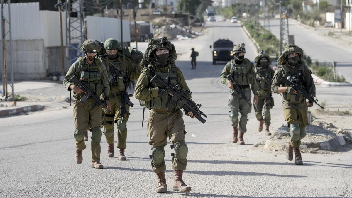 Israeli soldiers are seen in Balata, a Palestinian refugee camp in Nablus, West Bank, on Thursday, Nov. 23, 2023. AP