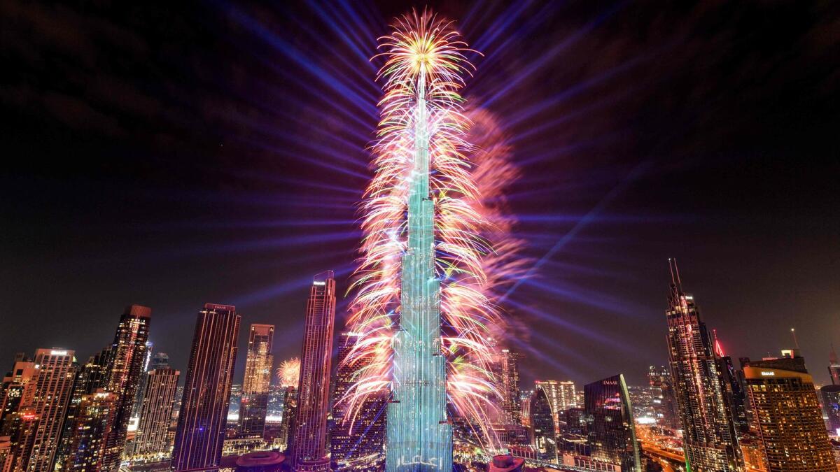 Fireworks light up the sky by the landmark Burj Khalifa skyscraper, the world’s tallest building, in Dubai at midnight on new year's eve. — AFP