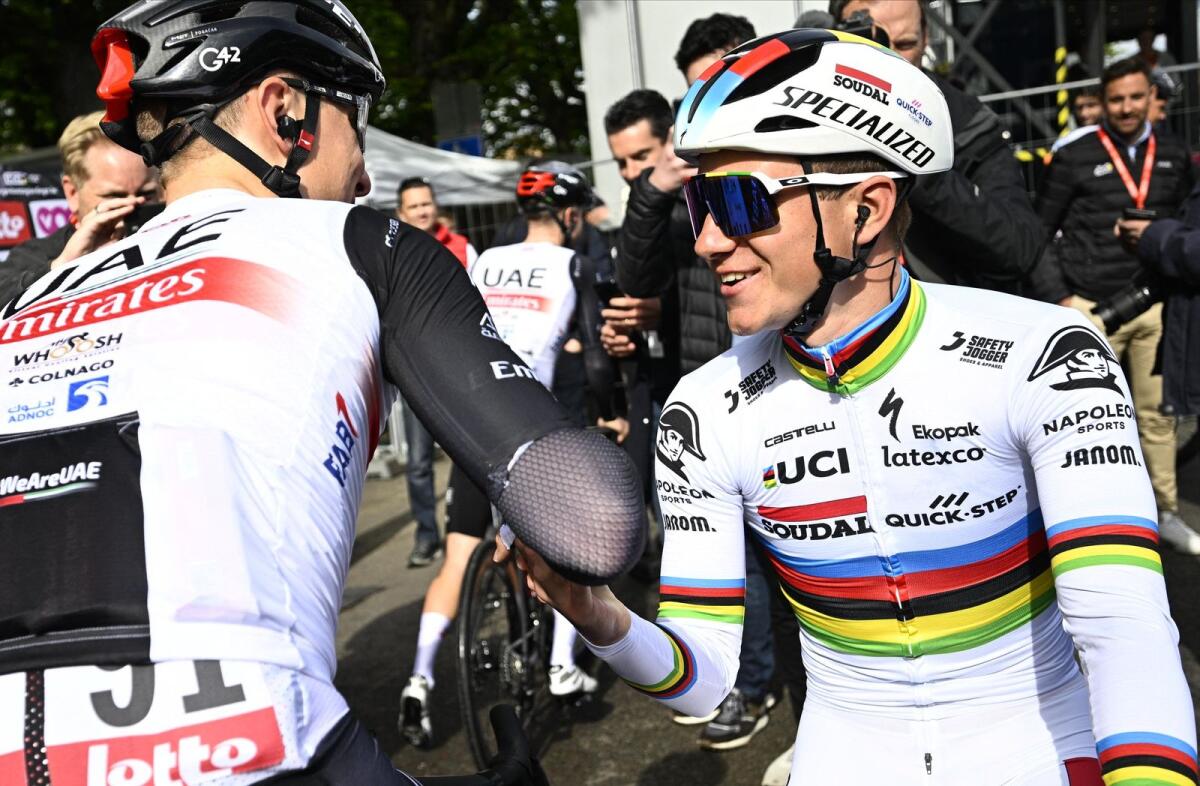 UAE Team Emirates' Tadej Pogacar (left) shakes hands with Soudal Quick-Step's Belgian rider Remco Evenepoel before the start of the Liege-Bastogne-Liege one day cycling event. — AFP