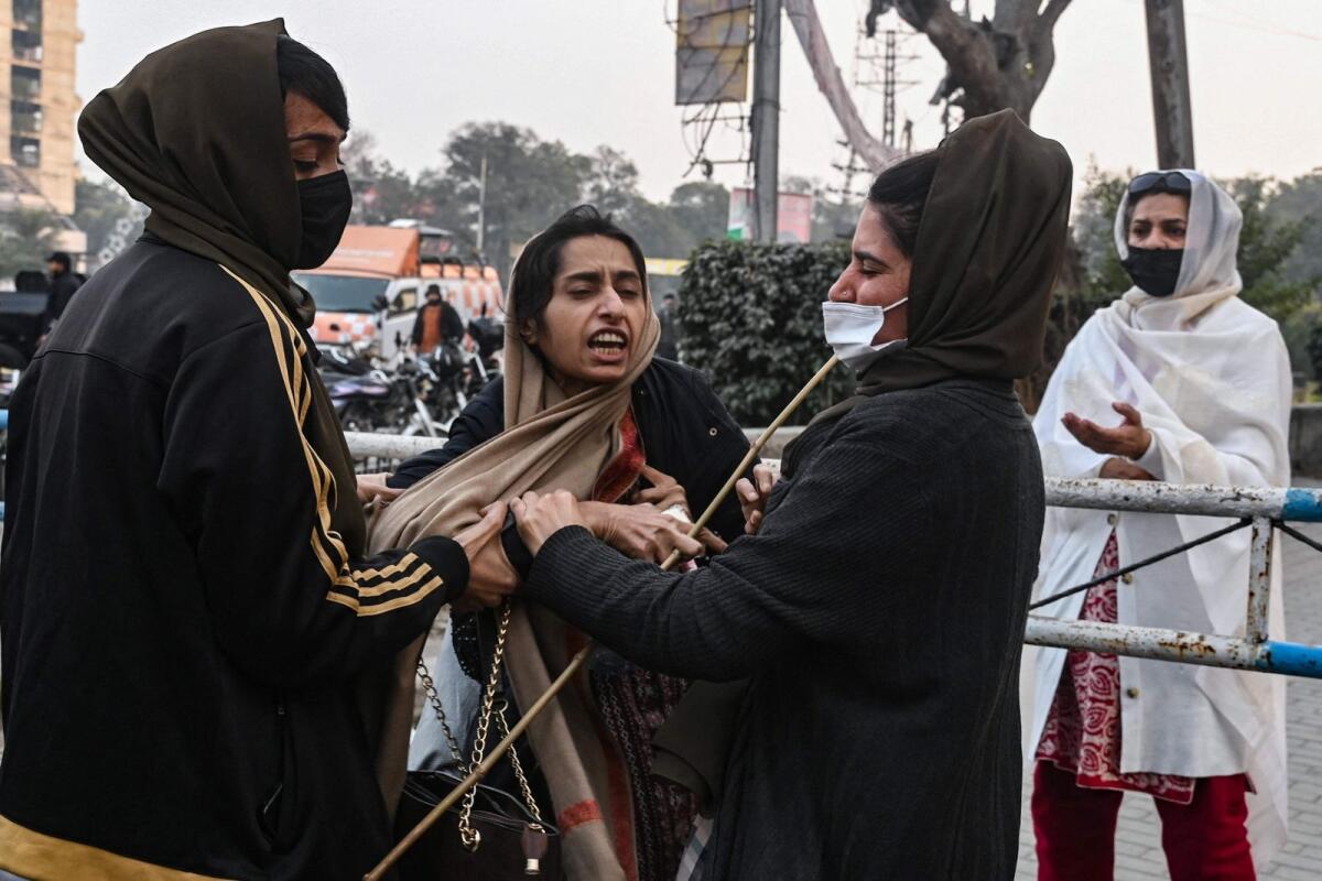 Police personnel detain a supporter of Pakistan Tehreek-e-Insaf party during an election campaign rally in Lahore on January 28, 2024. — AFP
