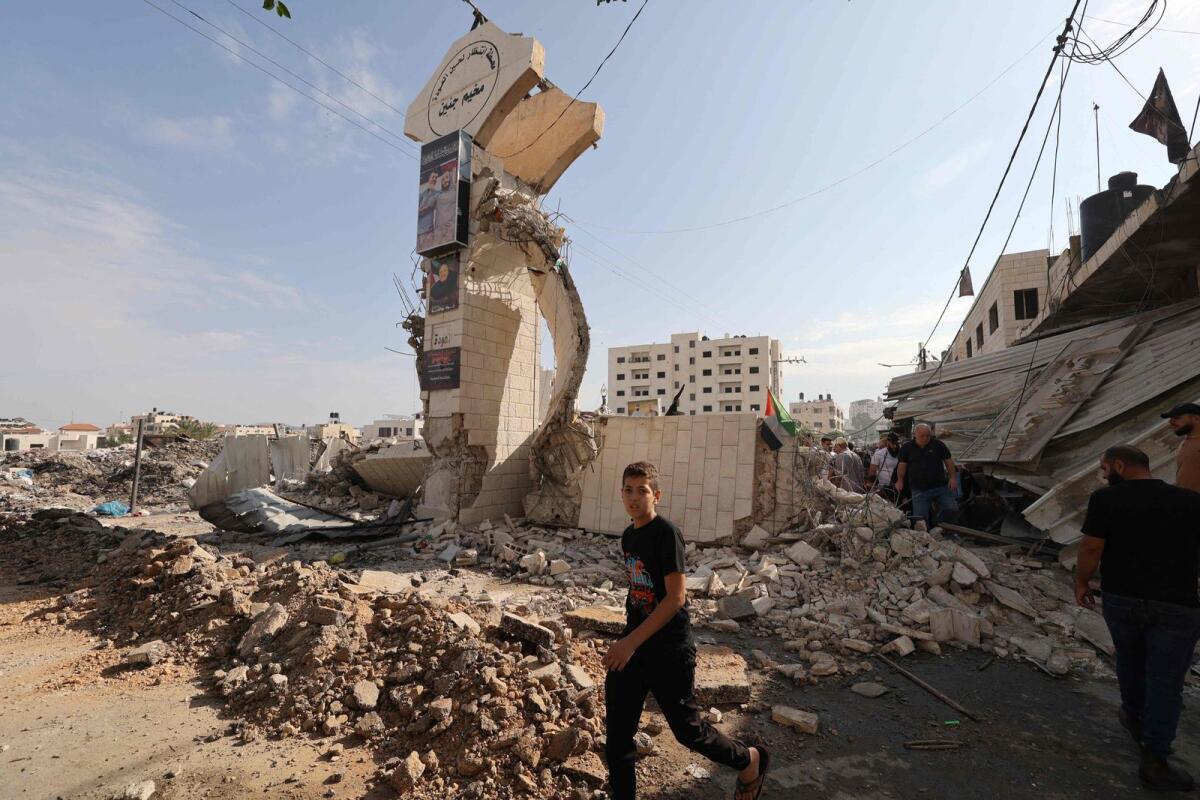 Palestinians survey the destruction following an Israeli military raid on the Jenin Palestinian refugee camp, in Jenin in the Israeli occupied northern West Bank on October 30, 2023,. Photo: AFP