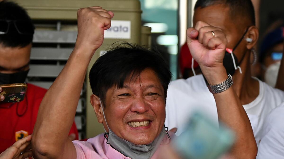 Presidential candidate Ferdinand Marcos Jr celebrates with supporters as he arrives at the campaign heaquarters in Manila on May 11, 2022. Photo: AFP