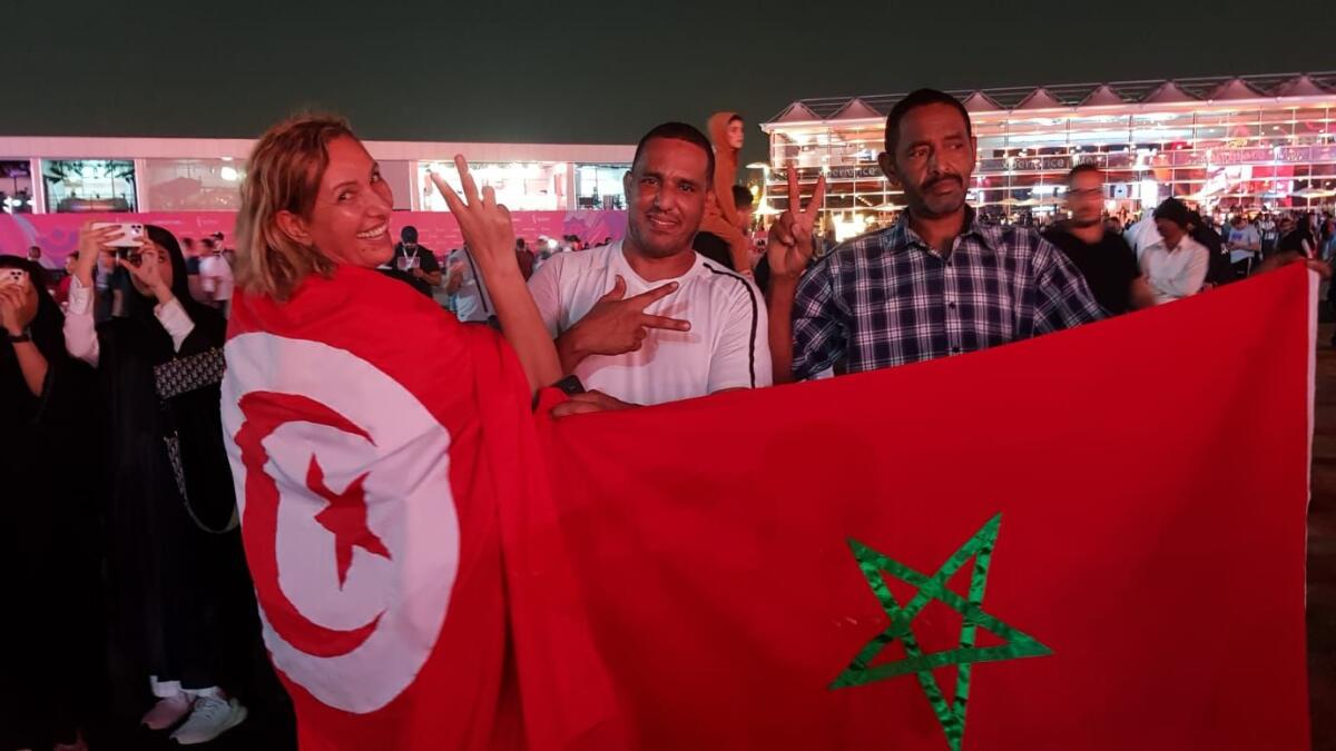 Morocco's Mustafa (centre) poses with fans from Tunisia.