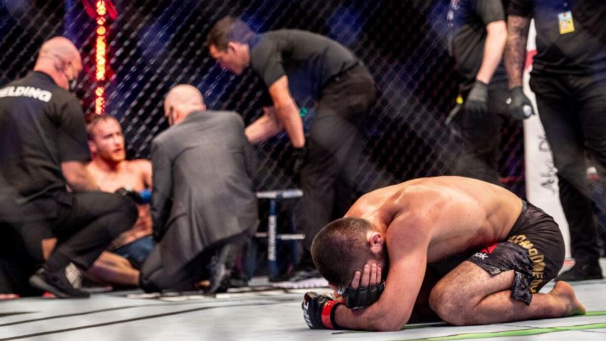 Khabib Nurmagomedov (right) reacts after his stunning win. (UFC Twitter)