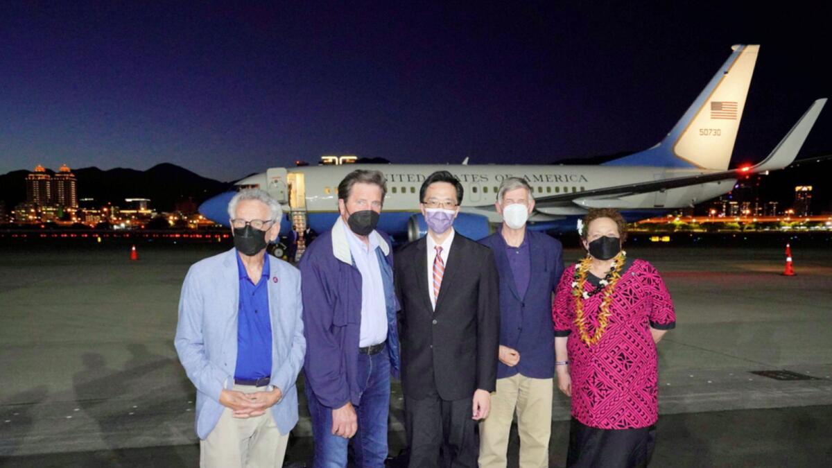 US lawmakers pose for a photo after arriving on a US government plane at Songshan airport in Taipei. — AP