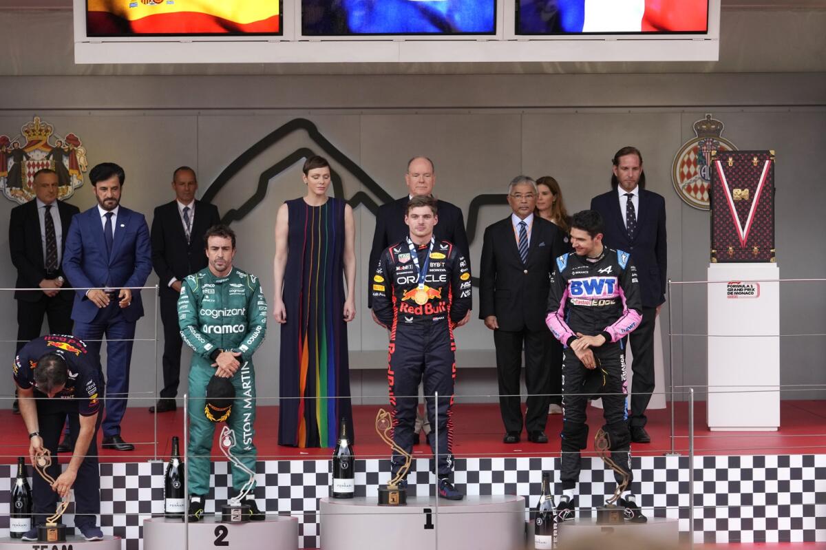 Fernando Alonso, Max Verstappen. and Esteban Ocon on the winner's podium at the Monaco Grand Prix. - AP