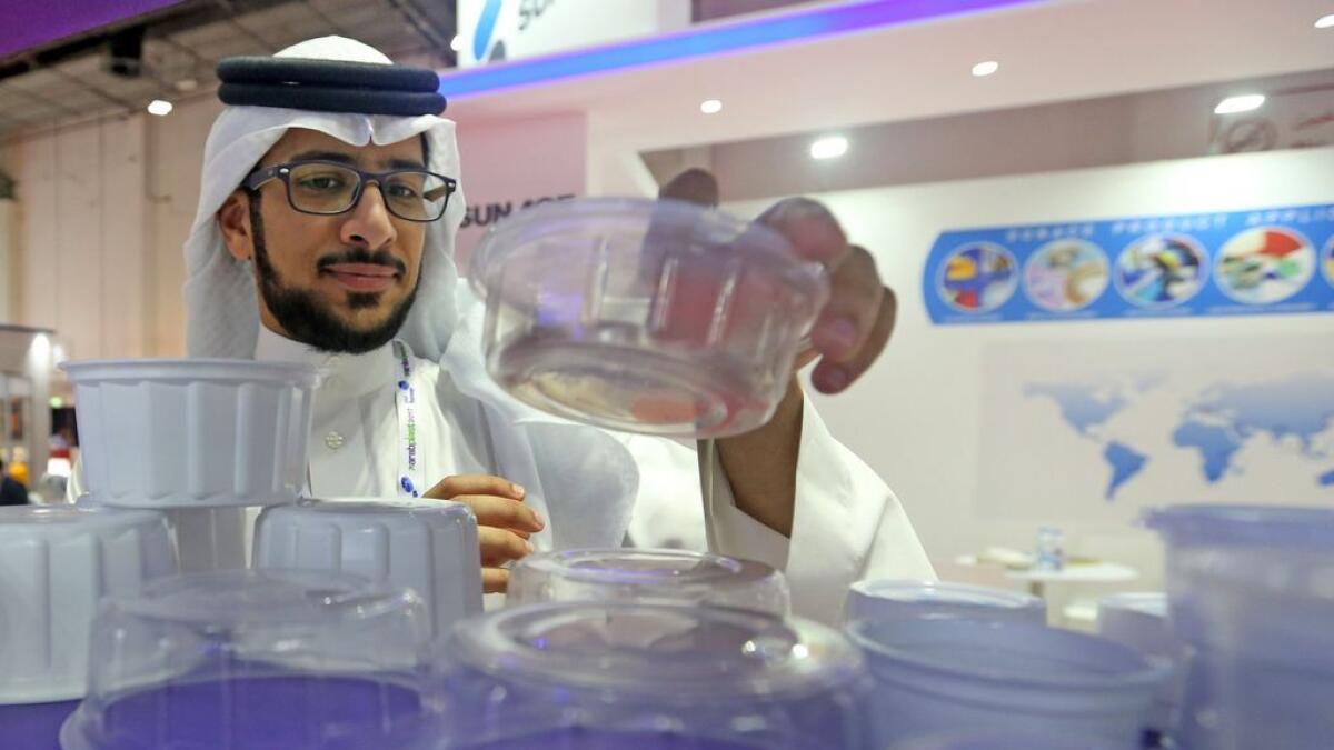 A visitor checks out Al Jabri plastic products during ArabPlast 2017 in Dubai.