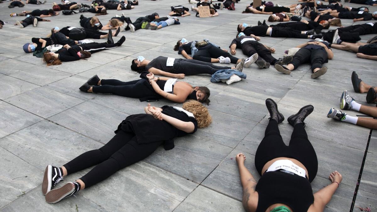 Protesters lie on the ground for 8 minutes and 46 seconds during a demonstration against racism on the occasion of the worldwide movement of the Black Lives Matter (BLM) protest against the recent death of George Floyd, in Bern, Switzerland, Saturday, 11 July 2020. AP