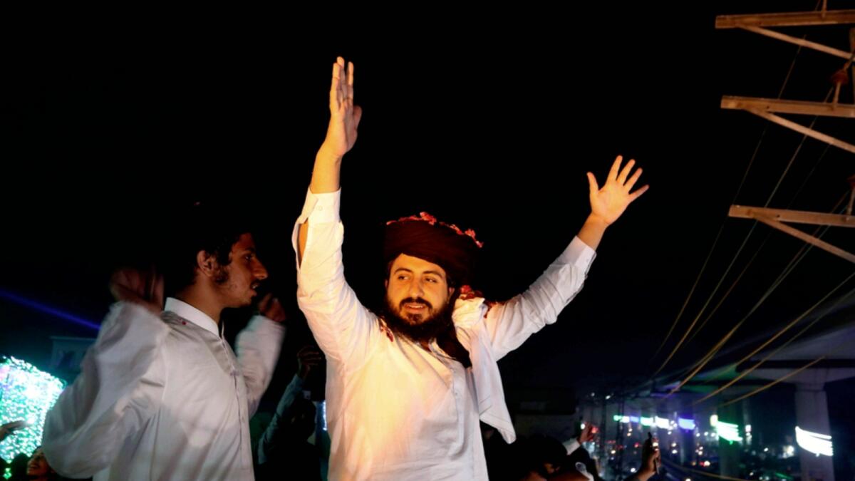 Saad Rizvi, head of Tehreek-e-Labiak Pakistan, waves to supporters following his release from custody in Lahore. — AP