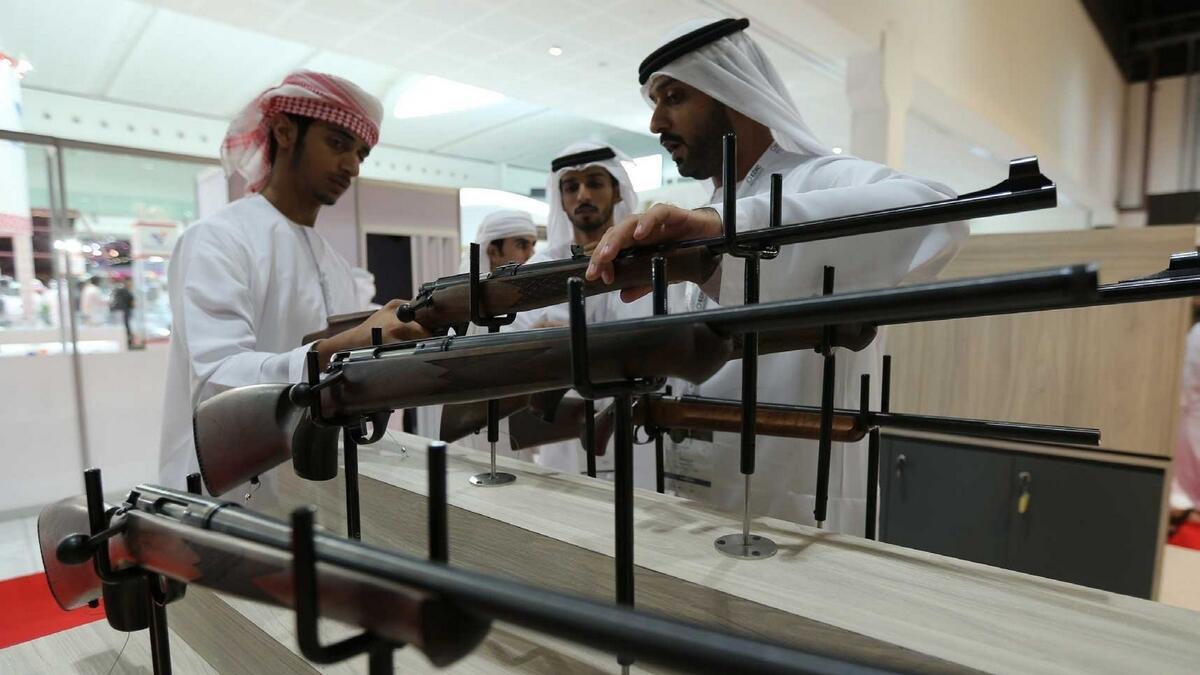 Visitors check out  hunting rifles during the opening day of Adihex last year. — File photo