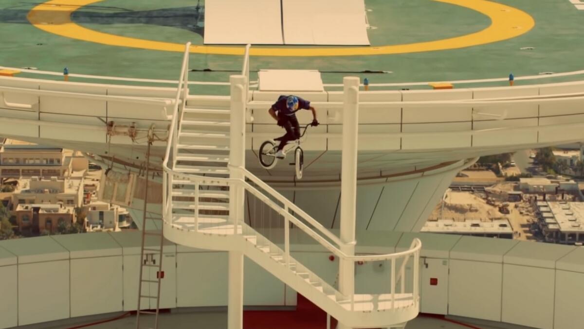 Video: Cyclist jumps on Burj Al Arab from chopper in incredible stunt