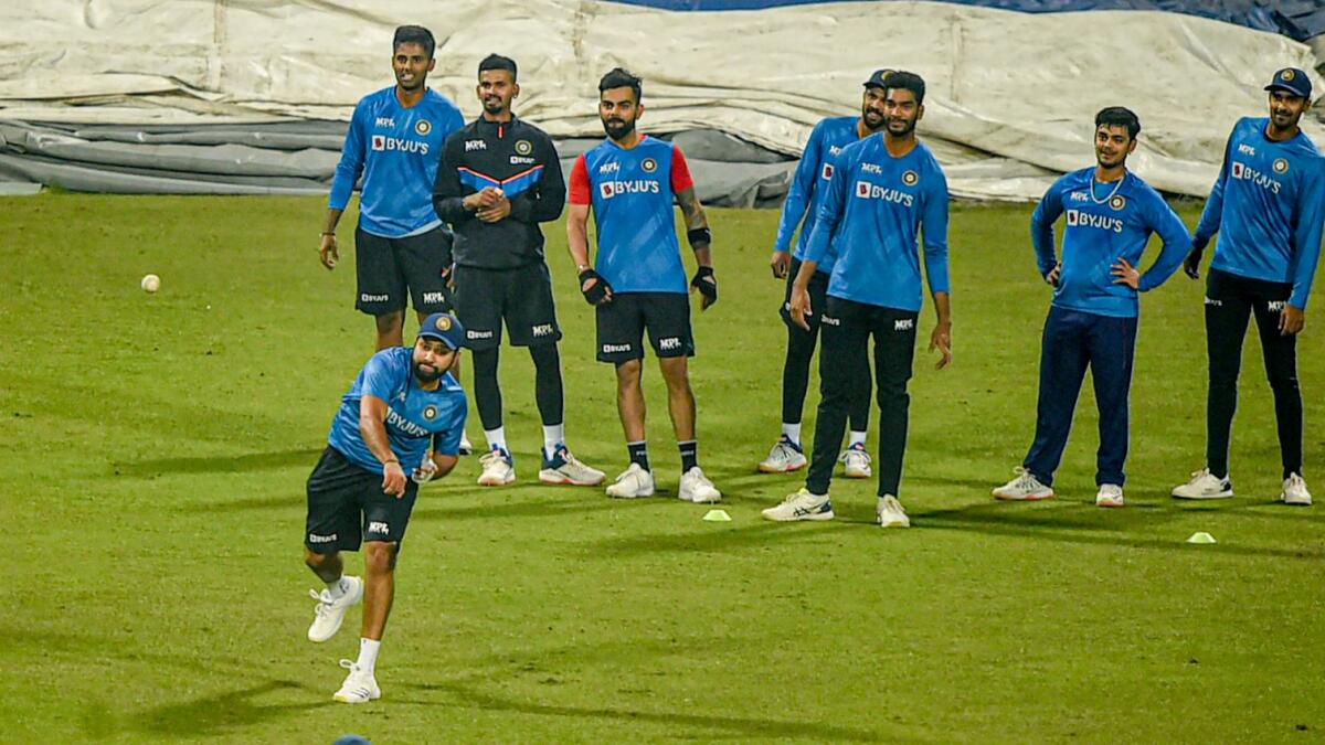 Indian captain Rohit Sharma throws the ball during a training session as his teammates look on. (PTI)