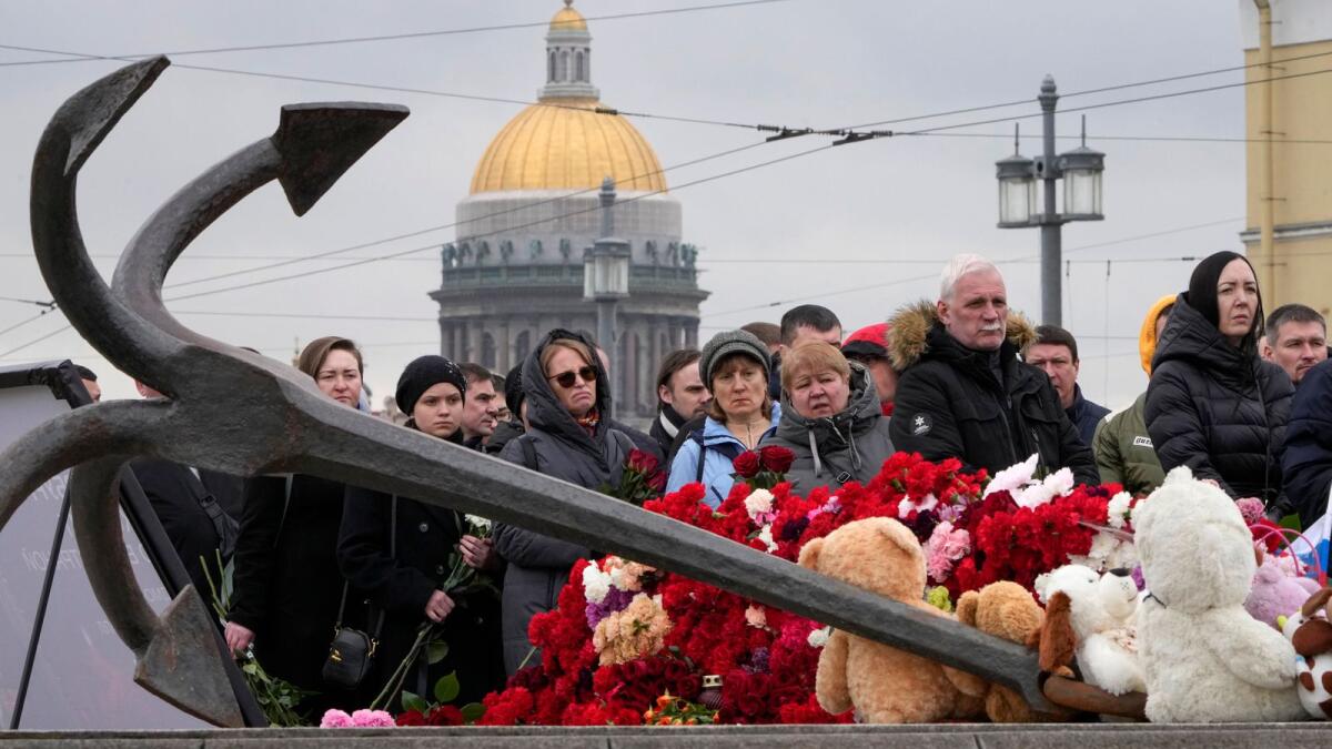 People lay flowers at a spontaneous memorial in memory of the victims of Moscow attack in St. Petersburg, Russia. — AP