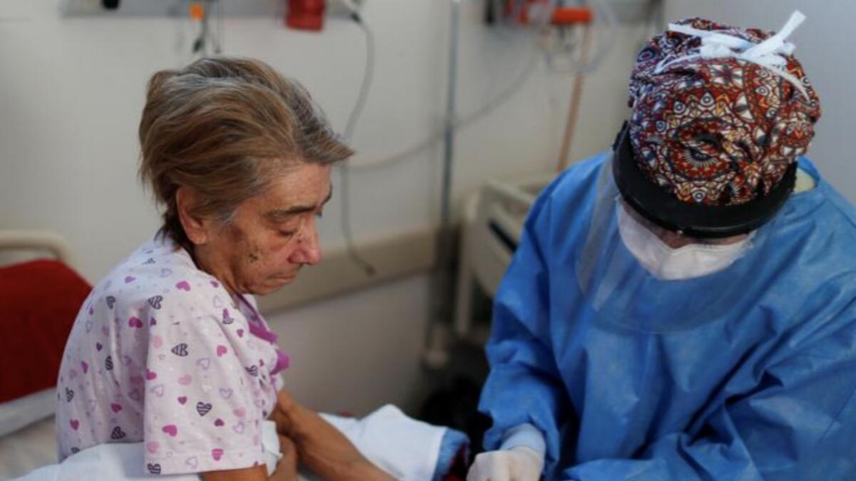 Dr. Mabel Diaz takes a blood sample from Elsa Paniagua, who is a coronavirus patient, in an ICU at the Dr. Alberto Antranik Eurnekian hospital, in Ezeiza.