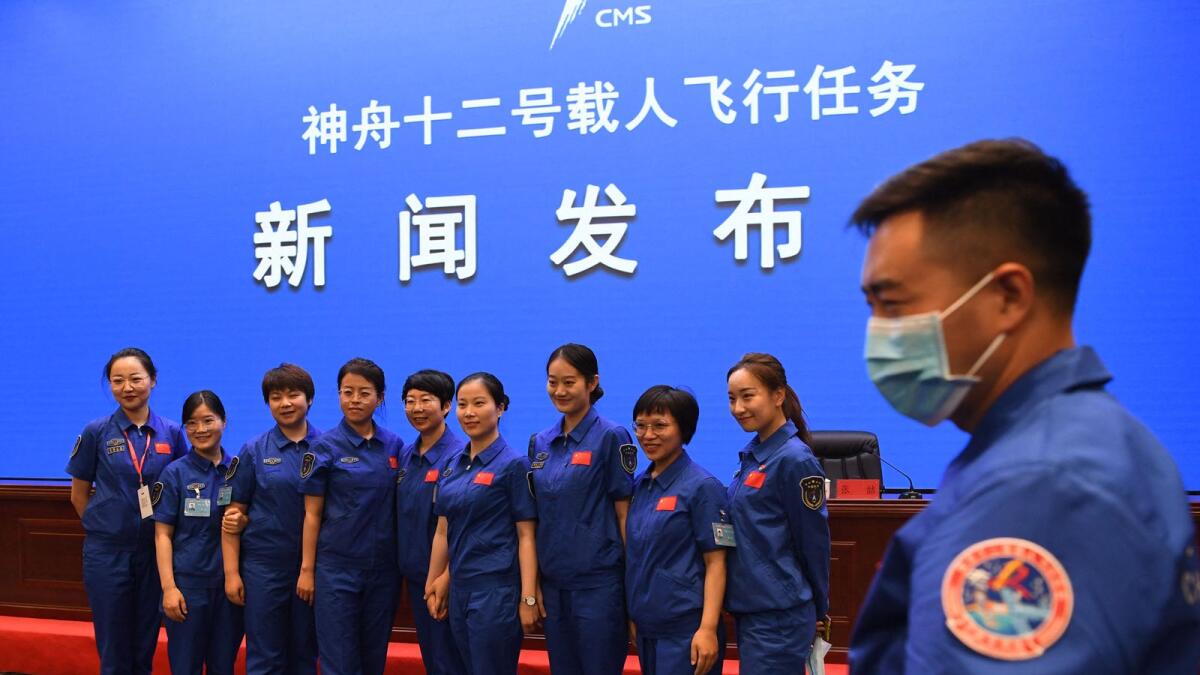 Staff members of the Jiuquan Satellite Launch Centre pose for photos prior to a briefing the day before the launch, at the Jiuquan Satellite Launch Centre in the Gobi desert. Photo: AFP