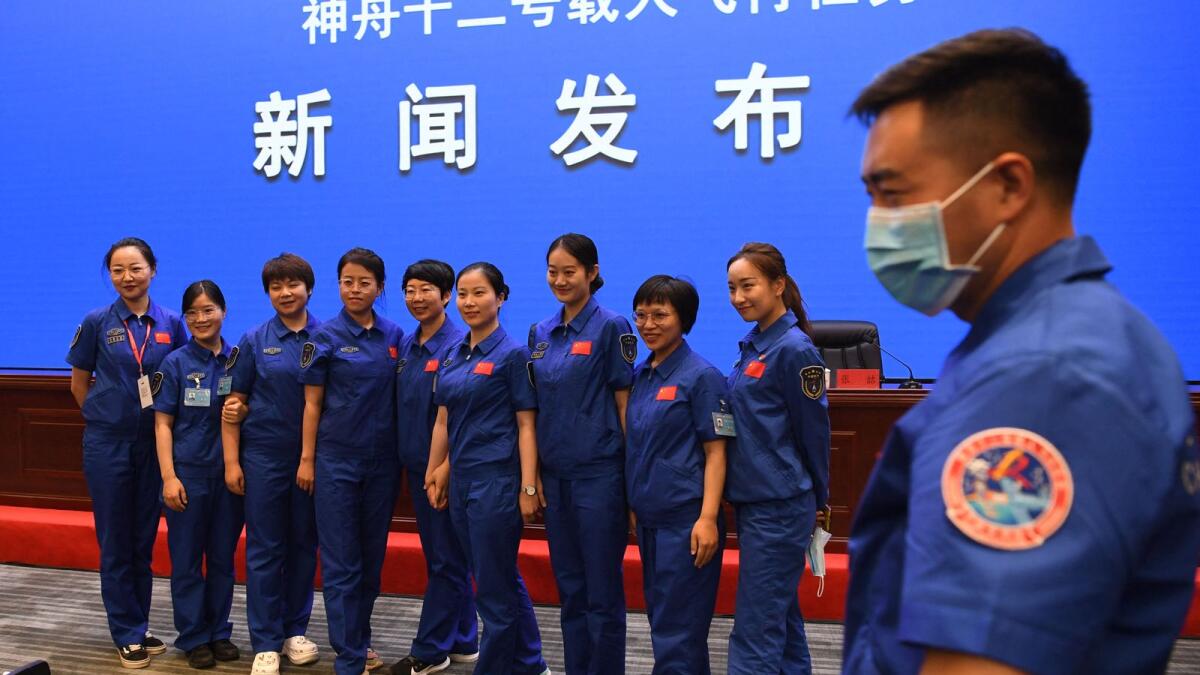 Staff members of the Jiuquan Satellite Launch Centre pose for photos prior to a briefing the day before the launch, at the Jiuquan Satellite Launch Centre in the Gobi desert. Photo: AFP
