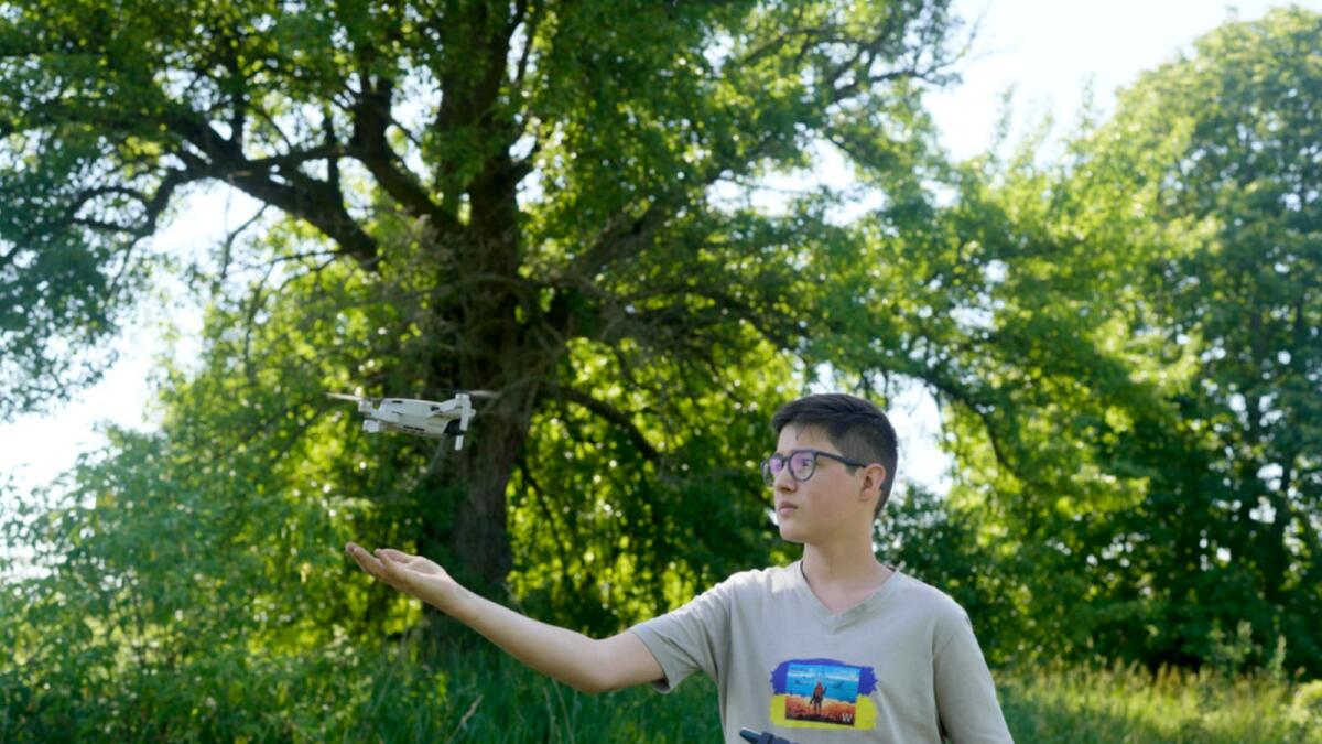 Andriy Pokrasa, 15, lands his drone on his hand. — AP