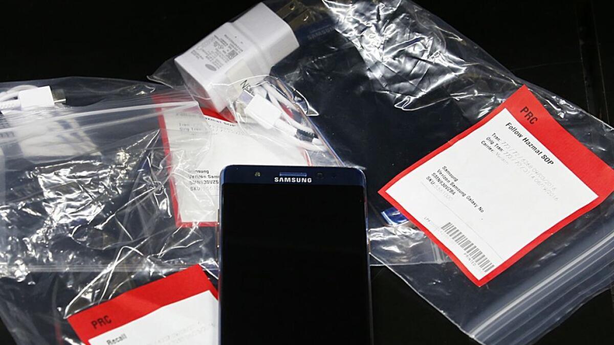 Several Samsung Galaxy Note 7s lay on a counter in plastic bags