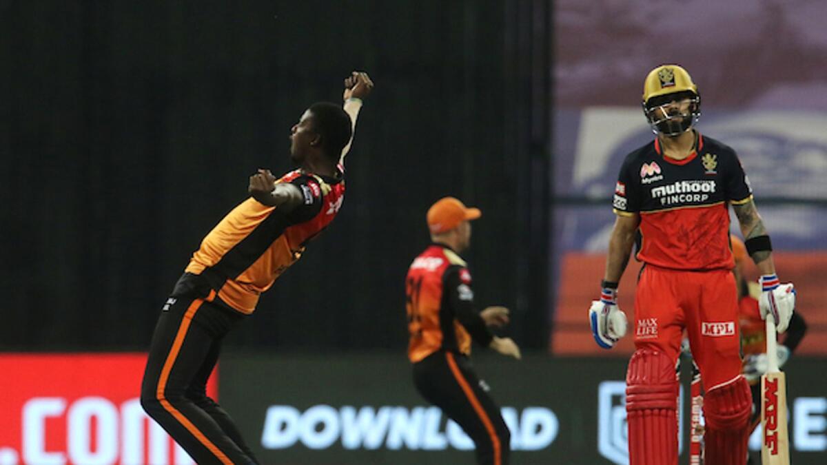 Sunrisers Hyderabad's Jason Holder (left) celebrates the wicket of Royal Challengers Bangalore captain Virat Kohli in Abu Dhabi on Friday night. — BCCI/IPL