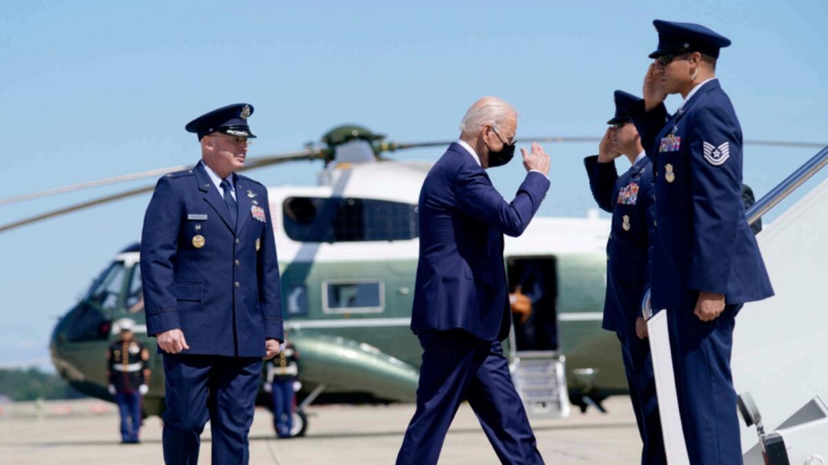 US President Joe Biden returns a salute as he walks to board Air Force One. — AP