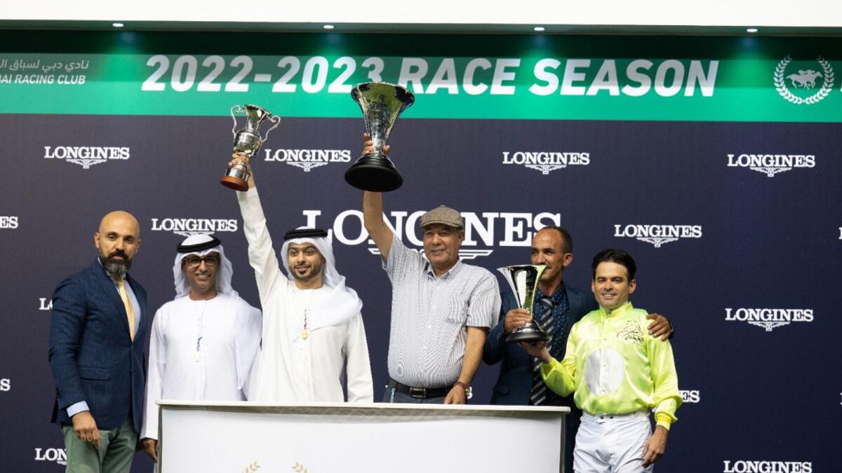 Winning trainer Ahmad Al Mehairbi celebrates after Kerless Del Roc won the Group 2 Madjani Stakes Present by Longines after receiving the trophy from Patrick Aoun (extreme left) Regional Longines Brand Manager for the Middle East &amp; South East Asia. KT photo by Shihab