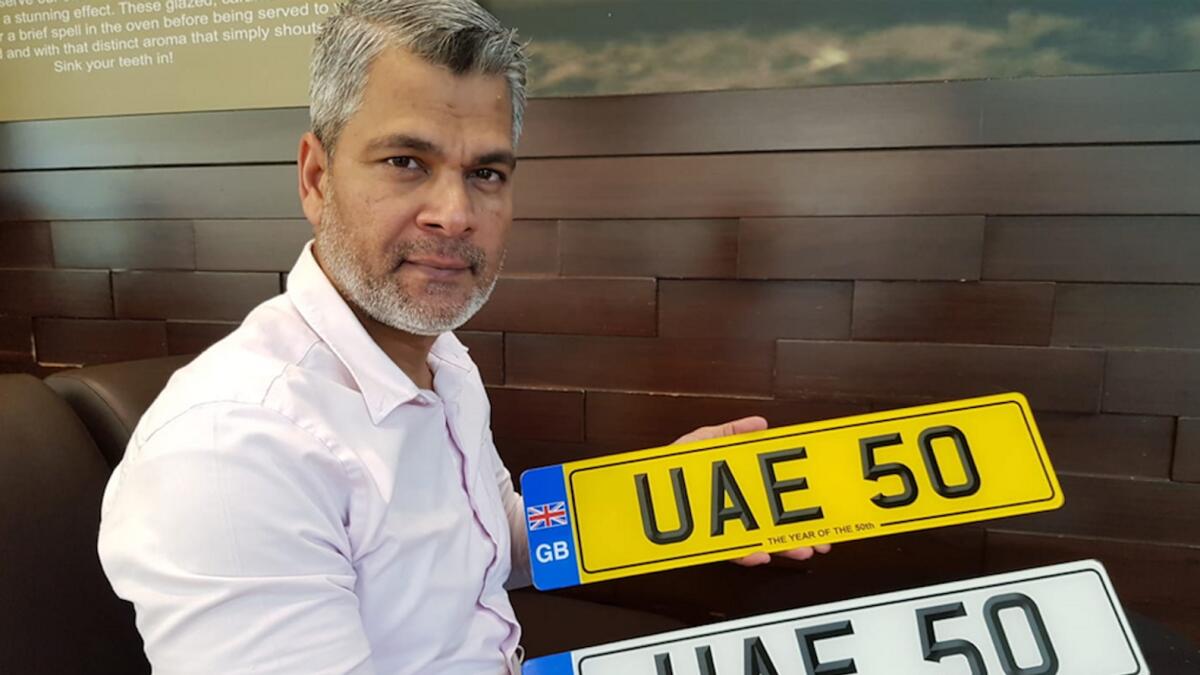 UAE-based motoring historian and author Mohammed Luqman Ali Khan with the ‘UAE 50’ number plates in Abu Dhabi. — Photo by Ashwani Kumar